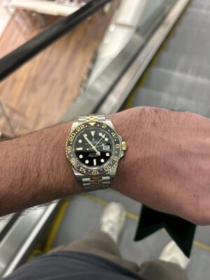 Superclone Zombie on wrist riding an escalator