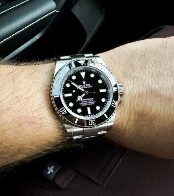 Submariner on wrist in car review image