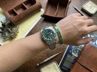 Close-up of a wrist wearing a sleek Green Submariner Titanium Steel Bracelet perfectly paired with a Submariner watch.