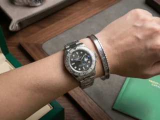 Close-up of a wrist wearing a sleek Silver Yacht-Master Titanium Steel Bracelet perfectly paired with a Yacht-Master watch.
